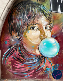 Paris street art showing girl blowing bubble